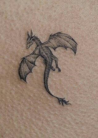 ₁₁₁ Dragon Tattoo Geometric, Book And Dragon Tattoo, Delicate Dragon Tattoo, Small Dragon Tattoo Designs, Sleeping Dragon Tattoo, Dragon Tattoo Behind Ear, Scotland Tattoo Ideas, Mini Dragon Tattoo, Abraxos Tattoo