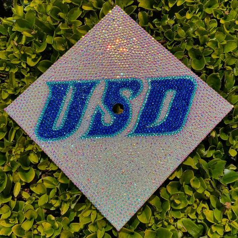 USD💙✨ #grad #gradcap #gradcapdesign #graduation #customgradcaps #rhinestone #bling #sandiego #university #college #handmade #fyp #etsy Rhinestone Graduation Cap Ideas, Rhinestone Grad Cap, Decorated Grad Caps, Rhinestone Graduation Cap, Senior Things, Grad Cap Decorated, Grad Cap Designs, Grad Caps, Graduation Photo