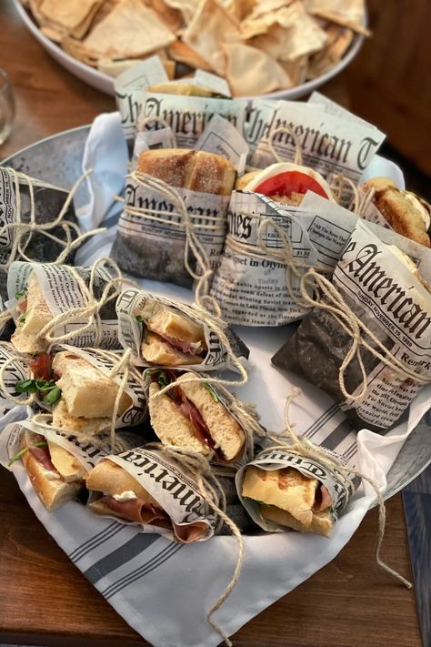 Newspaper wrapped sandwich, italian sandwich, party appetizer, finger foods Newspaper Sandwich Wrap, Sandwich Party Decorations, Finger Foods Packaging, Sandwich Wrapped In Paper, Deli Themed Party, Paper Wrapped Sandwiches, Sandwich Shop Aesthetic, Sandwich Packaging Ideas, Bake Sale Aesthetic