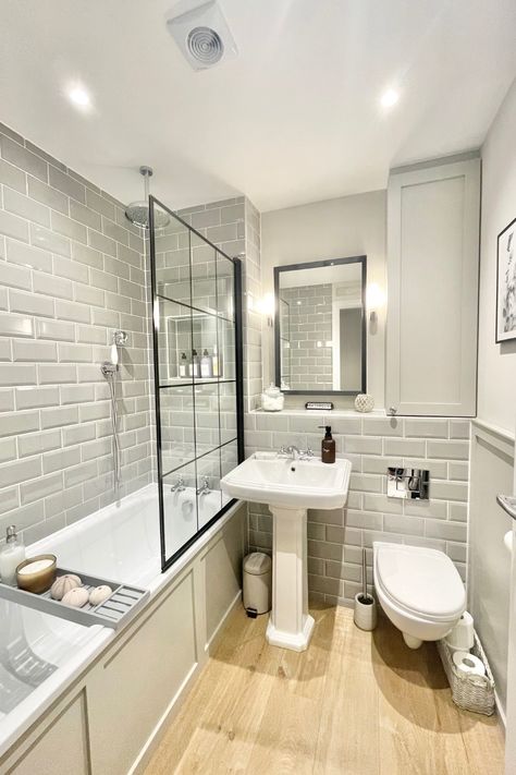 ✨ Classic charm meets modern sophistication in this timeless bathroom design! 🛁 The soft grey metro tiles paired with traditional elements like the pedestal basin create a sleek yet cosy feel. The wood-effect flooring adds warmth, while the black-framed shower screen introduces a bold, industrial touch. Perfect for a relaxing soak or refreshing start to the day. 🕯️🤍 @HouseNumberThree Grey Metro Tiles Bathroom, Metro Tiles Bathroom, Blue Toilet, Cosy Bathroom, Timeless Bathroom Design, House Renovation Design, Small Full Bathroom, Wood Floor Bathroom, Vintage Bathroom Decor