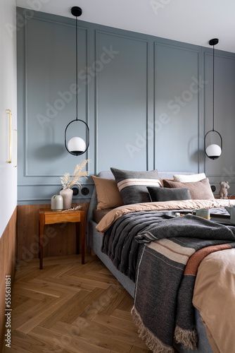 Stock Image: Interior design of cozy bedroom with brown and grey bedding, pillows, bedside table, vase with dried flowers, sculpture , hanging lamp and personal accessories. Home decor. Template. Grey Accent Wall Bedroom, Brown Grey Bedroom, Deep Blue Bedroom, Gray Accent Wall Bedroom, Blue And Grey Bedroom, Light Brown Bedrooms, Pretty Visuals, Vase With Dried Flowers, Flowers Sculpture