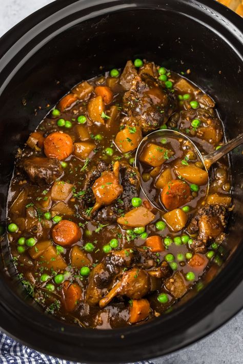 Tender slow cooker oxtail with carrots, peas, and potatoes smothered in rich gravy is hands down one of the easiest ways to prepare the best oxtail stew! Oxtail Slow Cooker, Slow Cooker Oxtail, Oxtail Stew, Crockpot Mac And Cheese, Mexican Chicken Casserole, Blueberry Breakfast Cake, Low Carb Appetizers, Quick Easy Desserts, Dinner Side Dishes