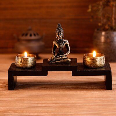 Create a calming atmosphere in your home with this decorative mini buddha statue and zen garden set. The statue and candle holders sit on a sleek dark brown wood frame with 3 raised platforms to create a well-balanced display. Set this display on your office desk, bedroom dresser, kitchen counter, or anywhere else to add unique cultural decor. With the soft glow of a candle casting light on the antique bronze colours, this decoration is sure to create a soothing atmosphere in any space. | Bungal Yoga Room Decor, Zen Home Decor, Buddha Decor, Meditation Room Decor, Sitting Buddha, Buddha Figurine, Zen Decor, Wood Candle Holders, Meditation Space