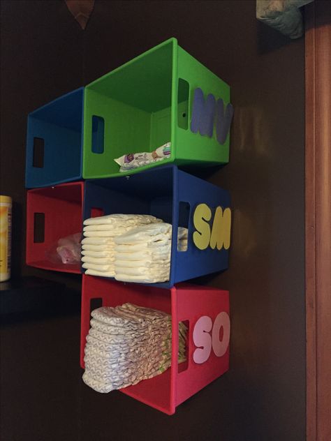 Inexpensive Diaper cubbies. These are made from colorful bins from the dollar store.  Each day care child has their own bin.  Parents can easily view and see when it is time to refill. Daycare Rooms Setup Storage Bins, Daycare Diaper Organization, Day Care Set Up Ideas, Daycare Storage Ideas, Daycare Toddler Room Ideas, Day Care Decor, Daycare Bathroom Ideas, Baby Classroom Ideas Daycares, Home Daycare Rooms Setup