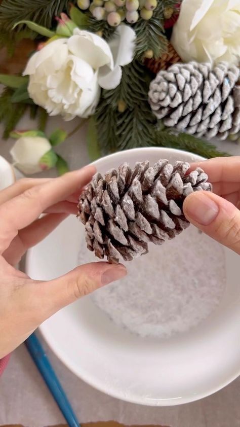 730 reactions · 593 shares | These snowy pinecones are the easiest DIY ever. You simply paint on Modpodge, and then dip them in flocking snow. They look so pretty and so magical. Give it a try. Then come back and share with me how it went. | 𝐓𝐚𝐦𝐦𝐲 🌿Lavender Brook Home🌿 | John Debney · Main Title Snowy Pinecone, Diy Pinecone, Diy Winter, Craft Rooms, Winter Diy, Christmas Table Decorations, Christmas Inspiration, Christmas Table, Christmas Eve