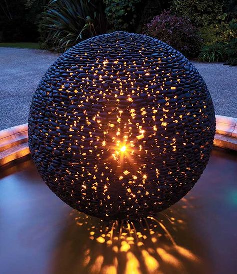 Dark Planet contemporary spherical garden art glowing at night Dark Planet, Garden Spheres, Garden Globes, Garden Balls, Garden Art Sculptures, Outdoor Sculpture, Garden Stones, String Lights Outdoor, Garden Ornaments