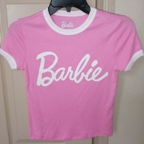 Barbie pink and white t-shirt Basic Logo Print T-shirt For Spring, Basic Tan Tops With Graphic Print, Cute Spring Tops With Logo Print, Cute Logo Print Tops For Spring, Trendy Tan Tops With Logo Print, 90s Style Pink Tops With Logo Print, Pink Logo Print Shirt For Spring, Spring Pink Shirt With Logo Print, Basic Logo Print Top For Spring