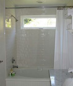 Transom window above bathtub area to allow natural light into a ... Window Above Tub, Bathroom Windows In Shower, Bathroom Window Treatments, Simple Bathroom Remodel, Bathroom Remodel Cost, Budget Bathroom Remodel, Small Bathroom Renovations, Window In Shower, Bathtub Remodel