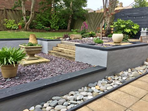 Originally sloping grass. Retaining walls built, lighting installed, back fill, planting, plum slate added and feature planting. Plum Slate Garden Ideas, Black Retaining Wall Garden, Slate Retaining Wall, Slate Water Feature Wall, Plum Slate, Slate Garden, Garden Features, Retaining Wall, Patio