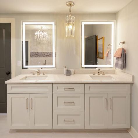 These bathroom mirrors have special lighting powers. Check out the scoop at HGTV.com. Pendant Light Between Bathroom Mirrors, 72" Bathroom Vanity, Master Bath With Lighted Mirrors, Bathroom With 2 Mirrors, Led Vanity Mirrors, 72" Bathroom Vanity Double Sinks, Double Vanities Bathroom, Bathroom Vanity Lights Over Mirror Ideas Master Bath, Led Mirror Bathroom Double Sinks