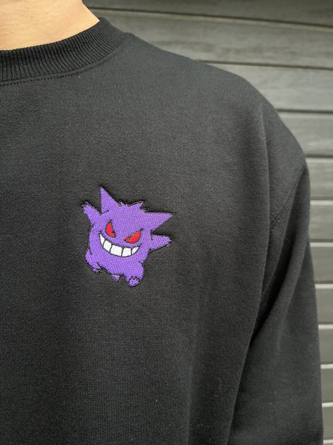 Features a left chest embroidery of Gengar on a soft and comfy sweater. About the sweatshirt: ❁65% polyester, 35% cotton ❁320 GSM ❁Low-pill fleece Also available on a t-shirt - see our other listings! Thank you for visiting the RTdesignsAU store! Please feel free to message us if you have any questions. Gengar Merch, Gengar Outfit, Gengar Embroidery, Anime Shirts Aesthetic, Gengar Hoodie, Gastly Pokemon, Fan Anime, Comfy Sweater, Embroidered Crewneck