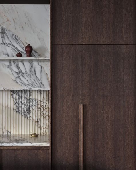 Soft shapes and playful textures come together in this dark stained oak wood kitchen. The white marble kitchen surfaces flow into the wall and its softly under-lit shelving, the stone’s beautiful imperfections adding a warm, organic aspect to the space. The Gaggenau 400 series oven in Anthracite blends in with the dark wood cabinetry and elevates the space while the matching 200 series flex induction cooktop combine a certain elegance with minimalistic design. Dark Stained Cabinets, Modern Walnut Kitchen, Dark Oak Cabinets, Walnut Kitchen Cabinets, Organic Modern Kitchen, Dark Wood Kitchen Cabinets, Dark Wood Bathroom, Dark Wood Kitchens, Walnut Kitchen