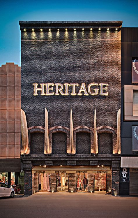 the interior revolved around the name heritage, recreating the weaving environment using typical detailing, enticing the customer into a relaxed yet dramatic shopping experience. \n Hotel Front Design, Restaurant Door, Retail Facade, Commercial Design Exterior, Retail Architecture, Shop Facade, Storefront Design, Facade Lighting, Shop Fronts