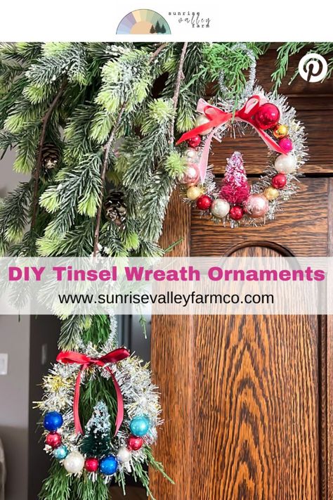 Handmade Tinsel Wreath Ornaments with Vintage Style] Miniature wreath ornaments adorned with shiny red, gold, blue, and silver baubles hang from snowy pine branches, each topped with a red ribbon. A small, festive tree sits inside each wreath. Text on the image says, "DIY Tinsel Wreath Ornaments, www.sunrisevalleyfarmco.com. Tinsel Ornaments Diy, Diy Tinsel Wreath, Diy Gift Toppers Christmas, Tinsel Wreath Diy, Christmas Ornament Wreath Diy, Diy Tinsel, Diy Ornament Wreath, Ornament Wreath Diy, Diy Xmas Decor