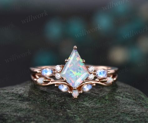 This ring is handmade by myself. The main stone is a 6x9mm kite cut Lab opal. The accent stones are round 1.5mm moissanites and marquise 2x4mm moonstones.. The wedding band stones are round lab opals and marquise moonstones. The material is solid gold(white,yellow,rose gold available) Ring size can be choose from the selection box. This jewelry can also be made in solid 10k,14k,18k gold,with real diamonds.Contact me! Need rush order? contact me! Need custom making order? Contact me! I have confidence on my jewelry.30 days money back guarantee!(For returned item,as this is handmade jewelry.Handcrafted fee and shipping fee will be deducted,others will be refunded soon) Thanks for your visiting! White Opal Engagement Ring, Opal Engagement Ring Rose Gold, Topaz Birthstone, Opal Engagement Ring, Engagement Ring Rose Gold, Opal Engagement, Engagement Rings Opal, Set Jewelry, Ring Rose Gold