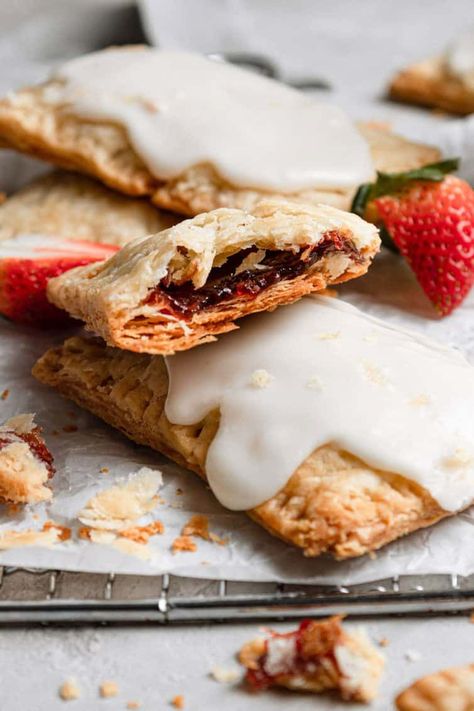 These easy, yet totally impressive homemade strawberry pop tarts are the perfect addition to your morning breakfast. Flaky pastry surrounds strawberry filling for a tender breakfast pastry that will disappear in a matter of minutes. Get ready to go completely berserk over this amazing homemade version of one of my childhood favorite treats! Brown Sugar Pop Tarts, Pop Tarts Recipe, Strawberry Pop Tarts, Filling Breakfast Recipes, Homemade Pop Tarts, Recipes For Game Day, Strawberry Pop, Pancake And Waffle, Brown Eyed Baker