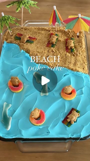 Sheri Wilson on Instagram: "Beach Jello Poke Cake! 🏖️  This was such an easy treat to make and my kids always love it!   Ingredients: 1 box white cake mix + prep ingredients  1 3oz box blue jello 1 cup boiling water 1 can white vanilla frosting  1 can blue vanilla frosting  1/2 cup graham cracker crumbs  Peach rings  Teddy grahams Sour belts  Gummy sharks  Beach umbrellas   1. Prepare the cake mix according to directions in the box, then allow to cool to room temperature. 2. Combine the box of jello with the boiling water and stir until the sugar has dissolved. Allow to cool but not set. 3. Poke holes all over the baked cake with a fork, then pour on the jello. 4. Spread the white frosting over half the cake, then blue over the other half. 5. Decorate with the candy, teddy grahams, and be Water Party Cake, Jello Pool Cake, Birthday Cake Jell-o Shots, Jello With Gummy Sharks, Pool Party Cake Ideas Boys, Beach Cake With Jello, Easy Beach Birthday Cake, Gummy Sharks, Sheri Wilson