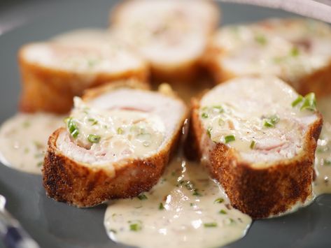 Chicken cordon bleu is a classic dish for the ages. It is also an accidental dish that has stood the test of time. Many believe chicken cordon bleu to be a French dish created by the famous Le Cordon Bleu cooking school. However, it originated in a Switzerland restaurant when two large bookings turned up and the cook did not have enough portions to serve everyone. The resourceful chef came up with the idea of making schnitzels and filling them with ham and cheese. The dish was so good, it was aw Food Network Chicken Cordon Bleu, Jeffrey Zakarian Recipes Food Network, Chicken Cordon Bleu Food Network, Geoffrey Zakarian Recipes, Dijon Cream Sauce, Cordon Bleu Recipe, Florence Food, Chicken Cordon Bleu Recipe, Cordon Blue