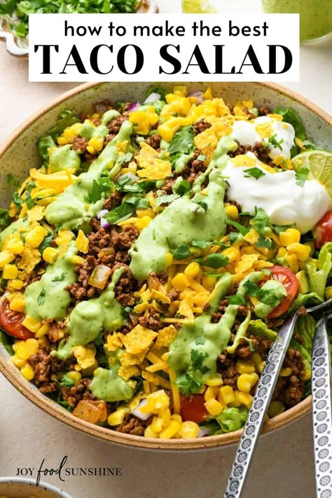 This is the best taco salad recipe! Lettuce, taco meat, veggies, herbs, cheese and toasted corn are tossed in a delicious homemade dressing for a bold, flavorful and delicious salad perfect for taco nights! Avocado Dressing For Tacos, Fiesta Taco Salad, Mexican Corn Slaw, Taco Salad For A Crowd Potlucks, Dressings For Taco Salad, Homemade Taco Salad Dressing, Taco Salad Recipe Dressing, Southwest Salad Recipes, Aztec Salad