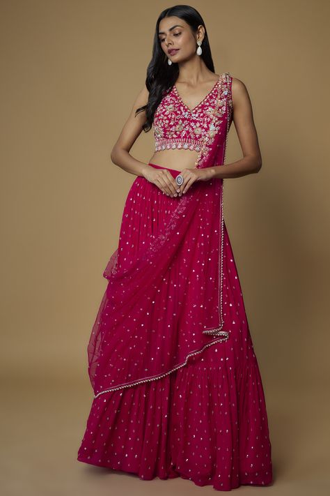 Featuring a pink flared lehenga in georgette base with sequins print. It is paired with a matching raw silk blouse having zardosi embellishment and a tulle pre-draped dupatta. . #perniaspopupshop #whatiworewastrending #ppuslove #lehengaset #lehenga #pinklehenga #pink Dark Pink Lehenga, Sleeveless Lehenga, Pink Blouses Outfit, Dark Pink Blouse, Lehenga For Girls, Flared Lehenga, Raw Silk Blouse, Lehenga Dupatta, Magenta Dress