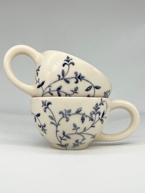 Introducing our charming Rustic Blue Floral Ceramic Mug, a delightful addition to your morning routine or relaxing evening tea time. Handcrafted with care and featuring a beautiful floral design in calming shades of blue, this mug is as functional as it is stylish. The rustic finish adds a touch of antique charm, making it the perfect choice for anyone who appreciates artisanal pottery. Treat yourself or surprise a loved one with this unique and lovely ceramic mug that is sure to brighten up any