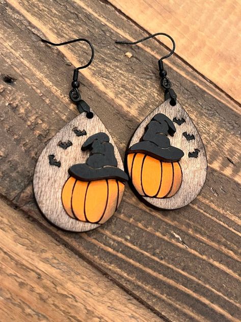 Embrace the spirit of fall with stylish pumpkin witch hat crafts featuring teardrop earrings and autumn-themed jewelry that celebrate the season! Pumpkin Witch Hat, Laser Engraved Earrings, Wood Jewelry Diy, Laser Cut Wood Earrings, Witch Earrings, Bat Earrings, Laser Engraved Ideas, Laser Cut Earrings, Stacked Earrings