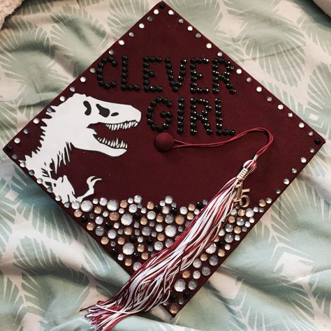 Clever Girl-Jurassic Park Graduation Cap Graduation Cap Designs How To Train Your Dragon, Jurassic Park Graduation Cap, Dinosaur Graduation Cap, How To Train Your Dragon Graduation Cap, Animal Science Graduation Cap Ideas, Pixar Graduation Cap, Clever Girl Jurassic Park, Creative Graduation Caps, College Grad Cap Ideas