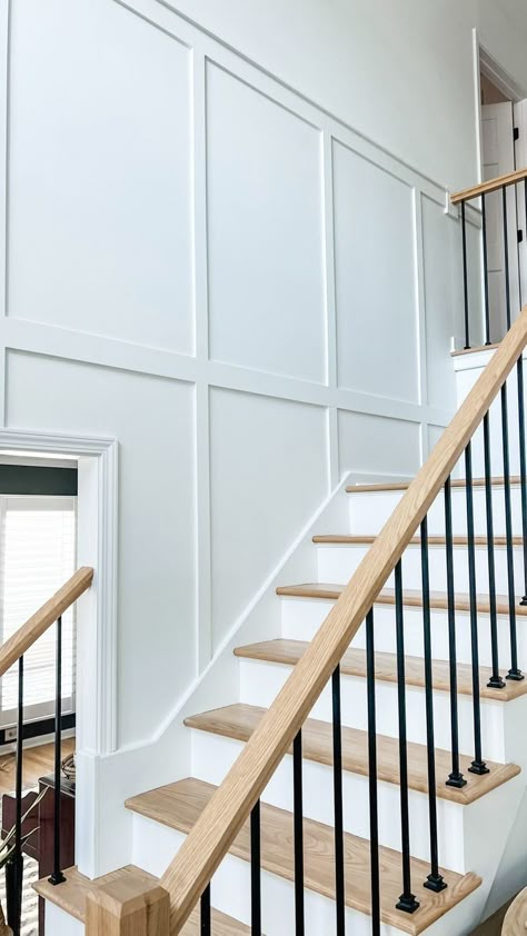 #crafts #stairsmakeover #renovation Tall Board And Batten Entryway, Stair Batten Board, Wall Paneling Under Stairs, Batten Board Walls With Crown Molding, Board Batten Staircase, Staircase Batten Board, Board And Batten Down The Stairs, Upstairs Hallway Board And Batten, Modern Colonial Stair Railing