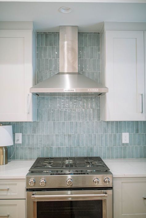 Coastal Blue Backsplash Kitchen, Pale Blue Tiles Kitchen, White Kitchen With Light Blue Backsplash, White Cabinets Blue Island Backsplash, Coastal Kitchen Inspiration, Coastal Kitchen Tile Backsplash, Cabinet And Backsplash Ideas, Coastal Condo Kitchen, Sea Glass Tile Backsplash Kitchen