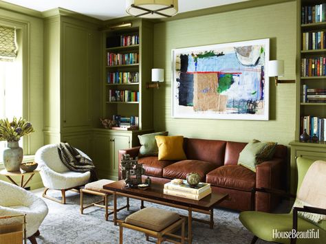 The library, with Farrow & Ball's Olive paint and Phillip Jeffries's Vinyl Thai Silk wall-covering, represents "a warmer zone."  Tommi Parzinger coffee table with pullout stools and Kurt Østervig chairs for Rolschau MØbler date from the 1950s. Sofa by A. Rudin. Rug by Stark. Monochromatic Living Room, Designer Paint Colors, Olive Green Walls, Green Living Room, Kabinet Dapur, Green Room, Room Paint Colors, Living Room Green, Paint Colors For Living Room