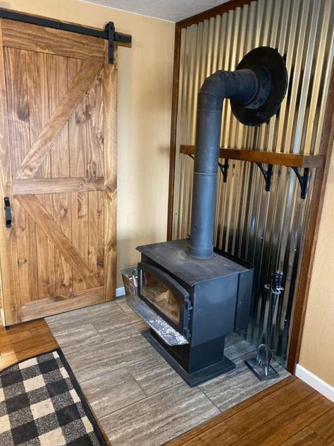 Rustic Wood Stove Wall, Cabin Wood Burning Stove Ideas, Tin Behind Wood Stove, Behind Wood Stove Wall, Wood Heater Ideas Living Rooms, Rustic Wood Stove Surround, Cabin Wood Stove, Wood Stoves Ideas Living Rooms, Woodstove Surrounds