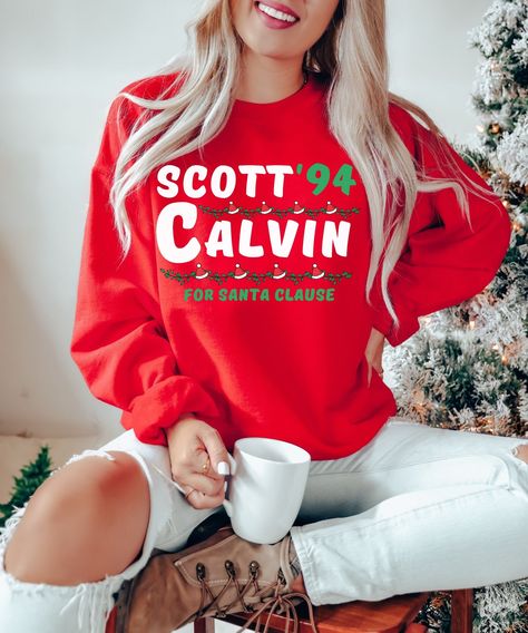 Scott Calvin For Santa Clause Sweatshirt | Santa Claus Shirt | 90s Movie Shirt | Christmas Sweater | Christmas Movie Shirt This is a fun election sweatshirt for Scott Calvin from the 1994 Christmas movie classic, The Santa Clause. It's a unisex Gildan crewneck made out of 50% cotton and 50% polyester. It's the perfect Christmas sweater for anyone who loves the movie or just wants to get into the holiday spirit! SIZE AND FIT: Your sweatshirt design will be printed on a high-quality, soft and comf Mama Shirts, Mama Sweatshirt, Christmas Mom, Womens Crewneck, Favorite Sweater, Brother Scan And Cut, Christmas Sweatshirts, Long Sleeve Pullover, Christmas Shirts