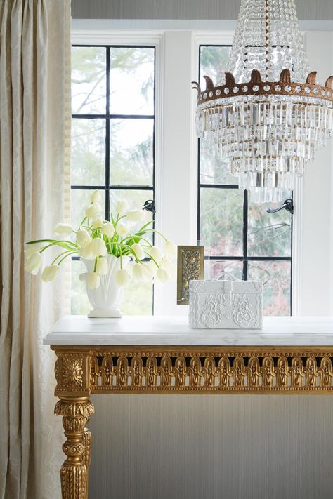 This lovely gilded library table is one of the highlights of this elegant master retreat. The gilded gold of this table is a real showstopper, very glamorous without being too stuffy. Consul Table, Marble Top Desk, French Office, French Desk, French Pleat, Pleat Curtains, Transitional Bedroom, Empire Chandelier, Gorgeous Bedrooms