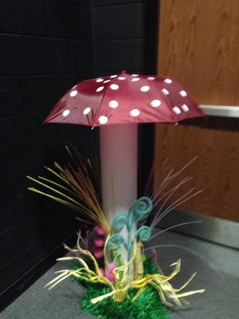 Giant mushrooms made from umbrellas resting inside painted carpet tubes Environment Exhibition, Wonka Decorations, Painted Carpet, Umbrella Decor, Mushroom Umbrella, Beta Club, Hoco 2023, Chocolate Factory Party, Willy Wonka Party