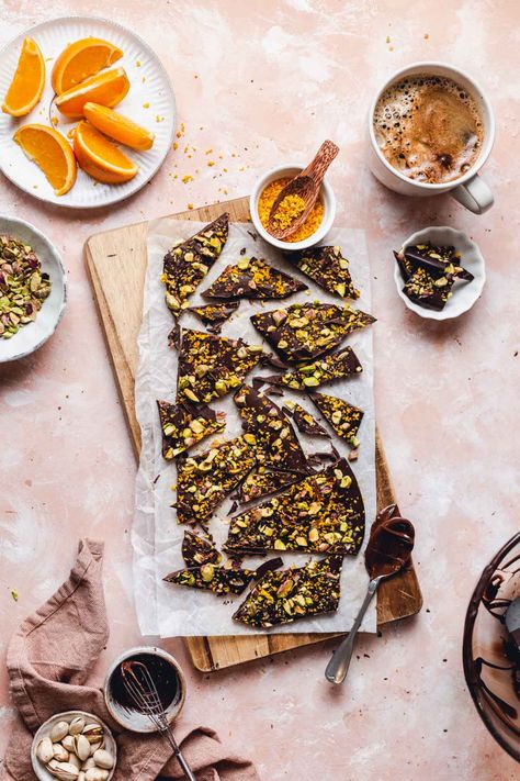 Homemade CBD chocolate bark covered with orange zest and pistachios. Easy recipe, infused with healthy CBD oil and full of expert tips on how to temper chocolate. This beautiful bar is vegan and gluten-free, the perfect way to enjoy comfort food with some added health benefits. Great gift idea for birthdays, Easter and Christmas, simply wrap it up with a ribbon and a personalised note. Can be infused with other flavours like mint, candy cane, pomegranate or even topped off with some pretzels. Ginger Turmeric Tea, Tempering Chocolate, Temper Chocolate, Vegan Minimalist, How To Temper Chocolate, Easter Dishes, Food Photography Props, Chocolate Nuts, Chocolate Bark