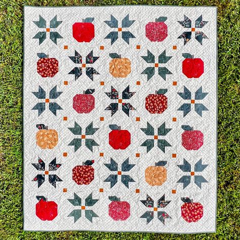 Crisp, cool air brings beautiful autumn leaves and delicious apples! Apple cider, apple butter and apple pie are staples of the fall season. This quilt features New England quilt blocks nestled with apples. Apple Butter Days quilt is sure to make your home and the shorter days cozier! 3 Sizes - 53" x 63", 73" x 83" and 93" x 103" Recommended for Intermediate Level Quilters. Traditional Piecing. YouTube Video available for this quilt on our YouTube Channel - https://www.youtube.com/channel/UC9qwP7DoT86BB1CFTeTKrrQ Pictures feature Seasons and Spice Fabric Collection by Art Gallery Fabrics Apple Quilt, Fall Quilt Patterns, Half Square Triangle Quilts, Easy Quilt Patterns, Fall Quilts, Fall Apples, Triangle Quilt, Precut Fabric, Beautiful Autumn