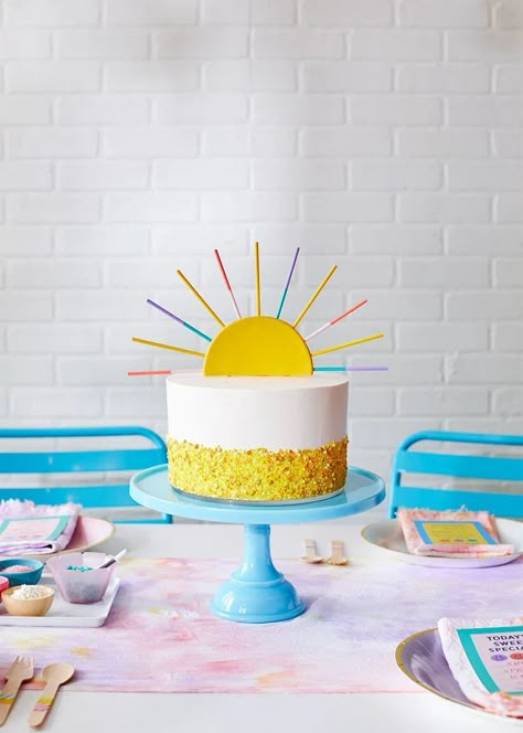 Frosted white birthday cake with yellow sprinkle band around the bottom decorated with a DIY Summer Sun Cake Topper; birthday party setting. Yellow Frosting Cake, Sun Smash Cake, Easy Diy Cake, Sunshine Birthday Cakes, Sun Cake Topper, Diy Cake Toppers, Crayola Model Magic, Sun Theme, Sun Cake