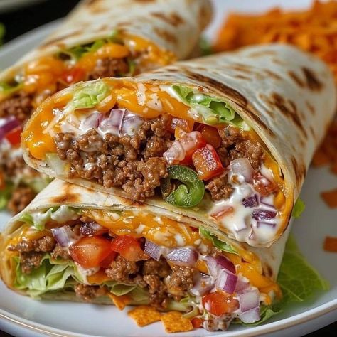 Nacho Cheese Beef Wrap 🌯😋❤️  ￼  Ingredients: 1 pound lean ground beef 1 cup Nacho Cheese Sauce ½ cup Sour Cream 1 can Rotel (green chilis with diced tomatoes) ½ cup chopped green peppers ½ cup diced onions 1 packet Taco Seasoning Mix Nacho Cheese flavored Doritos, crushed 4 flour tortilla wraps Shredded lettuce  Directions: Cook the Beef: Brown the ground beef in a skillet over medium heat until fully cooked. Drain any excess fat. Add Vegetables: Add the chopped onions and green peppers to the skillet and cook for an additional 4 minutes until softened. Season the Beef: Stir in the taco seasoning mix and cook according to the package instructions. Prepare Cheese Mixture: In a separate bowl, mix together the Rotel and Nacho Cheese Sauce until well combined. Assemble Wraps: Lay the flour t Big Mac Wrap, Big Mac Rolle, Green Chilis, Beef Wraps, Nacho Cheese Sauce, Hearty Comfort Food, Food Babe, Tortilla Wraps, Nacho Cheese