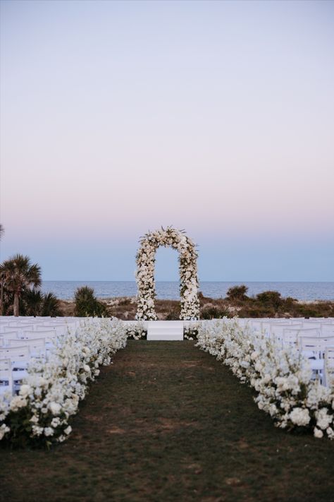 A stunning beachside wedding ceremony featuring a white floral arch and cascading floral aisle, set against the ocean and sky. Perfect inspiration for a romantic and elegant outdoor wedding.
beach wedding ceremony, white floral archway, wedding aisle flowers, romantic wedding setup, elegant beach wedding, outdoor wedding inspiration, beach wedding, wedding ceremony, wedding decor, wedding inspiration, wedding ideas, elegant wedding, wedding planning, event decor, seaside wedding ideas. Floral Archway Wedding, Seaside Wedding Ideas, Archway Wedding, White Floral Arch, Wedding Aisle Flowers, Floral Aisle, Wedding Ideas Elegant, Elegant Beach Wedding, Elegant Outdoor Wedding