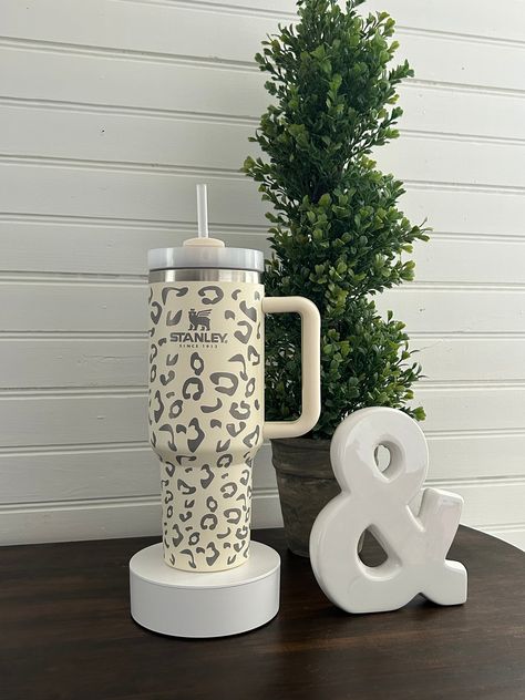 Introducing our Cheetah Laser Engraved 40 oz Cup with Straw!  The sleek leopard/cheetah design adds a touch of wild flair to your on-the-go lifestyle. Make a statement and stay hydrated with this unique and eye-catching piece.  While this is engraved as such, it is NOT an authentic Stanley brand cup but offers the same durability and style. Cheers to combining style and practicality! Copo Stanley, Stanley Brand, Cheetah Design, Stanley Cups, 40 Oz Tumbler, Cute Cups, Cup With Straw, Stanley Cup, Stay Hydrated