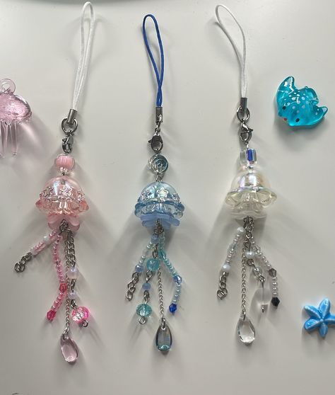 ˗ˏˋ ♡ ˎˊ˗ Matching jellyfish phone charm  ˗ˏˋ ♡ ˎˊ˗ ♡ ̆̈ Product details These phone straps are inspired by jellyfish with each one being different from the next. These cute little jellyfish have stars on the bell to make it. Each one is carefully handmade, ensuring a unique and personalized touch. ♡ ̆̈ Dimensions and specifications ◦ Length: 17cm ◦ Materials: phone strap with brass ends and iron ring  Please note that due to the handcrafted nature of each keychain, there may be slight minor visual differences. Additionally, the colours can vary from what you see on your screen due to monitor differences. We sincerely thank you for your understanding and really hope you enjoy this lovely addition to your daily life  If you have any questions at all, please don't hesitate to message me! ૮₍ Jellyfish Phone Charm, Phone Beads Strap, Diy Jewlry, Phone Beads, Cute Camera, Pretty Jewelry Necklaces, Phone Straps, Being Different, Fairy Crafts