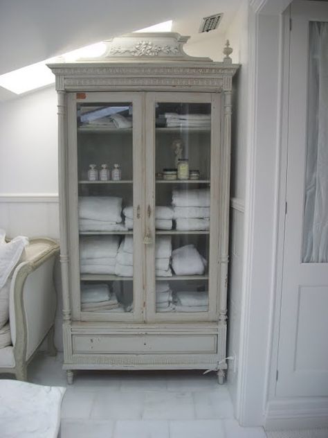 Repurposed glass-front armoire is used for storage in the bathroom - Full Bloom Cottage: Romantic French Cottage.... Glass Bathroom Cabinet, Decorating With Antique Furniture, Baños Shabby Chic, Linen Cupboard, Bathroom Linen Cabinet, Linen Cabinet, Glass Cabinet Doors, French Cottage, Glass Bathroom