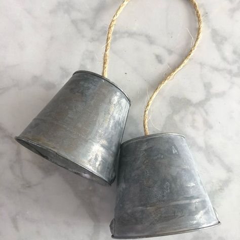 This is a fun simple project. If you loved the galvanized look, you're going to love how this bucket bell wreath t Your first step is roughing up two buckets with stainless steel scrubbing pads. Then pour toilet bowl cleaner all over them and let them sit for 2 to 4 hours or more depending on how rustic you want them (Make sure it is not natural toilet bowl cleaner. You want the harsh stuff).Next rinse them off thoroughly using rubber gloves to protect your hands. Step… Bell Wreath Diy, Christmas Galvanized Bucket, Natural Toilet Bowl Cleaner, Heavenly Christmas, Bucket Crafts, Diy Concrete Patio, Jean Quilts, Cork Planters, Bell Wreath