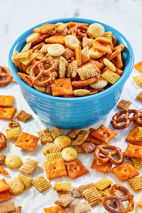 Get ready to score big at your next party with Cheesy Ranch Chex Mix! This mouth-watering snack is a touchdown of flavors, combining the crunch of Chex cereal, mini pretzels, oyster crackers, ranch seasoning, and Cheez-Its, all tossed in a flavorful butter blend and baked in the oven. It’s simple to make and perfect for sharing. Get the easy recipe and find out how to make the best homemade cheesy ranch Chex Mix. Oyster Crackers Ranch, Cheesy Chex Mix, Cheesy Ranch Chex Mix, Ranch Chex Mix Recipes, Ranch Chex, Homemade Chex Mix Recipe, Oyster Crackers Recipe, Ranch Chex Mix, Chex Snack Mix