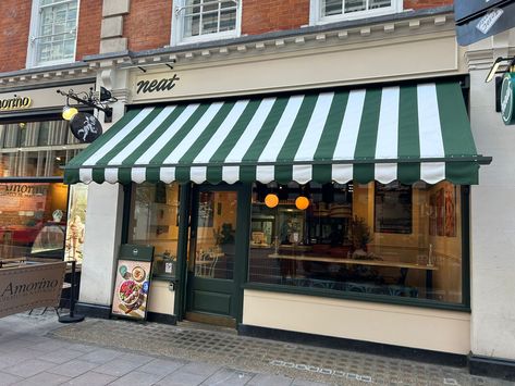 Neat Burger at Buckingham Palace Road ordered a new traditional Victorian awning which was fitted last week.   The cover is a very individual bespoke stripe which is eye catching from a distance and advertises their brand well.   At Radiant Blinds we have improved the traditional Victorian awning over time to ensure they can cope with the inclement British weather.  For example we have replaced some of the boxing with a more resistant aluminum casing at the top and back. Cafe Awning Store Fronts, French Cafe Awning, Restaurant Awning, Victorian Awning, Cafe Awning, Blinds For Bifold Doors, Shop Awning, Free Standing Pergola, Canvas Awnings