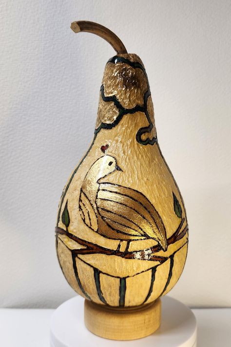 This hand-carved gourd, adorned with three of my favorite birds: the cardinal, dove, and owl. The journey began with a sketch upon the gourd's surface, followed by woodburning, where lines  give a sense of motion. Each bird was ink dyed and I added a touch of shimmer upon the birds and the clouds, while intricate carvings added texture for depth. Sealed with polyurethane, this piece rests upon a naturally-toned wood disk. A truly unique treasure, it would delight any bird enthusiast or nature af Wood Disc, Gourd Art, Gourds, The Clouds, Art Object, The Birds, Wood Burning, Sculpture Art, Hand Carved