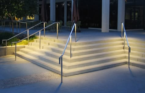 LR6 Lightrail™ Series is a complete illuminated handrail system, ideal for indoor or outdoor applications such as stairs, ramps, and walkways. The square design provides symmetrical or asymmetrical illumination with dimensions that conform to ADA requirements. Lightrail is offered in post or wall mount configurations, linear or point-source LED illumination, and integral or remote power supplies. Other uses include balustrade, guardrail, and elevator grab-rail illumination. Handrail Lighting Outdoor, Handrail Lighting, Stairs Lighting, Outdoor Handrail, Lighting Landscape, Creighton University, Glass Facade, Step Lights, Stainless Steel Handrail