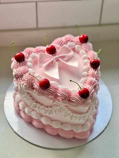 8 inch fake heart cake topped with cherries 🍒 Girly Heart Shaped Cake, Heart Cake Box Diy, Fake Heart Cake, Valentines Lambeth Cake, Cherry Topped Cake, Cute Valentines Cake Ideas, Pink Vintage Cake With Bows, Cake For Valentines Day Ideas, Girly Heart Cake