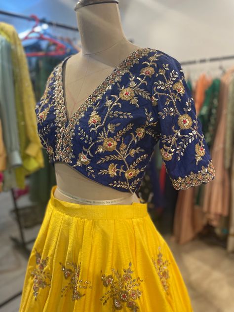 Royal blue deep v neck blouse with hand embroidered cutwork paired with sundhinr yellow color lehenga Yellow And Blue Lehenga, Royal Blue Blouse Designs, V Neck Lehenga Blouse, Customised Lehenga, Blue Work Blouse, Deep V Neck Blouse, Blue Blouse Designs, Golden Blouse, Fashionable Saree