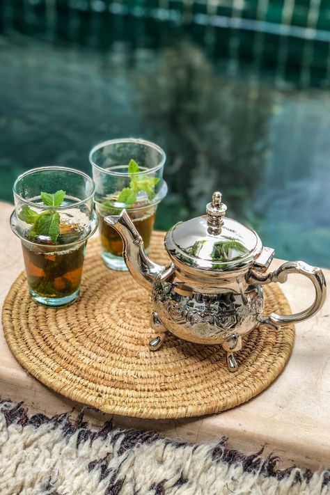 shiny silver tea pot with two glass tea glasses sat on the side of a green tiled pool Moroccan Tea Cups, Tea Campaign, Tunisian Wedding, Morocco Riad, Morocco Decor, Riad Marrakech, Moroccan Tea, Moroccan Mint Tea, Marrakech Travel